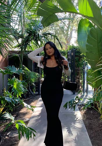 Reviewer in long strapped black maxi dress 