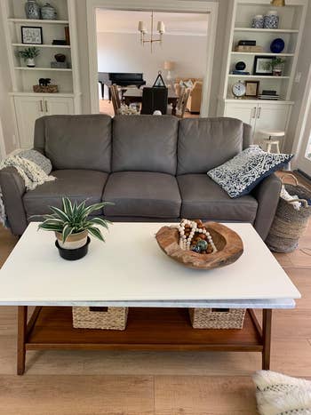a reviewer's white mid-century modern table with decor on top