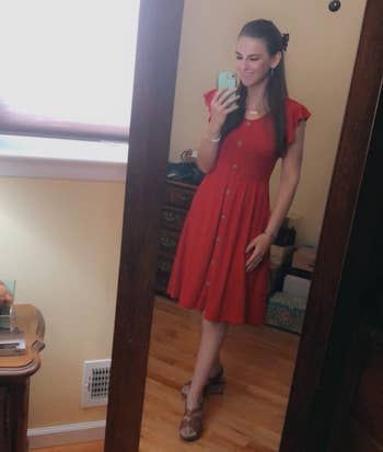 Image of reviewer wearing red dress