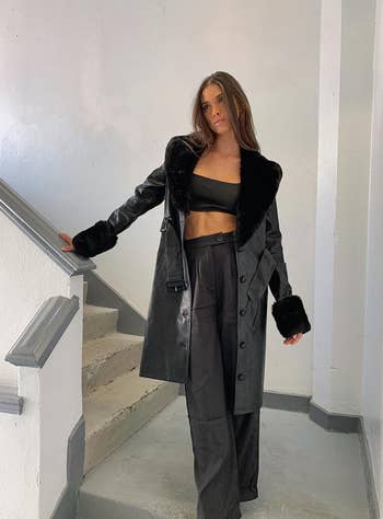 model posing in black faux leather coat