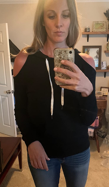 a reviewer wearing the hoodie in black