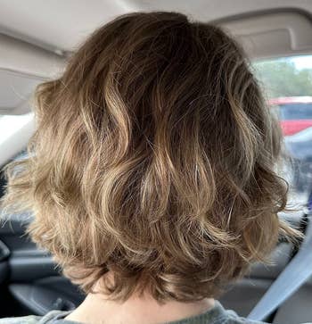 reviewer with short soft-looking wavy hair