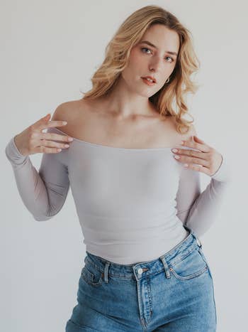 A model in the light grey top