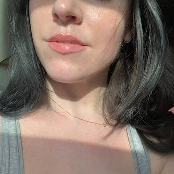 A reviewer showing their hydrated, glossy lips