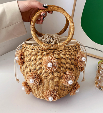 rattan bucket bag with flower and pearl embellishments
