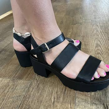 a reviewer wearing the sandals in black 