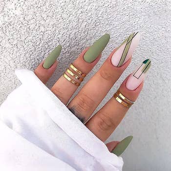model's hand with green and pink abstract nail design