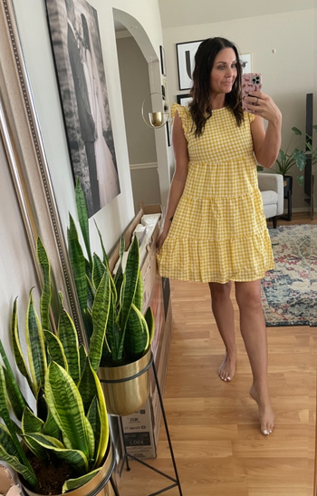 reviewer wearing plaid yellow dress