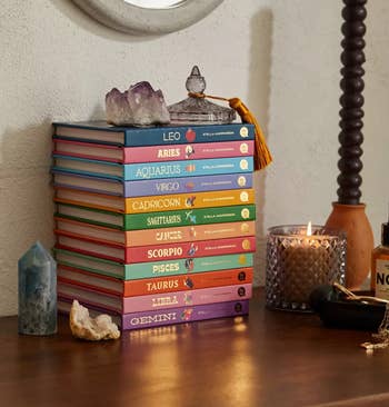 12 books in different colors stacked on top of each other 