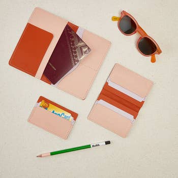 pink and red passport holder, wallet, card holder
