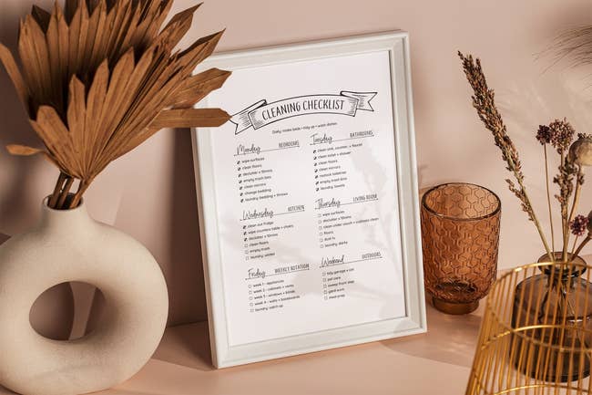 printed checklist with each room assigned a day of the week and a checklist of tasks to do to clean and organize that room