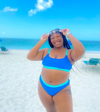 a reviewer wearing the blue and cyan colored suit