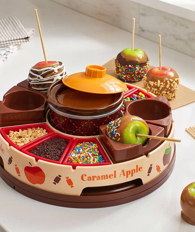 Caramel apple decorating kit with a lazy susan, trays for toppings, apple sticks, and a melting pot for easy caramel or chocolate dipping