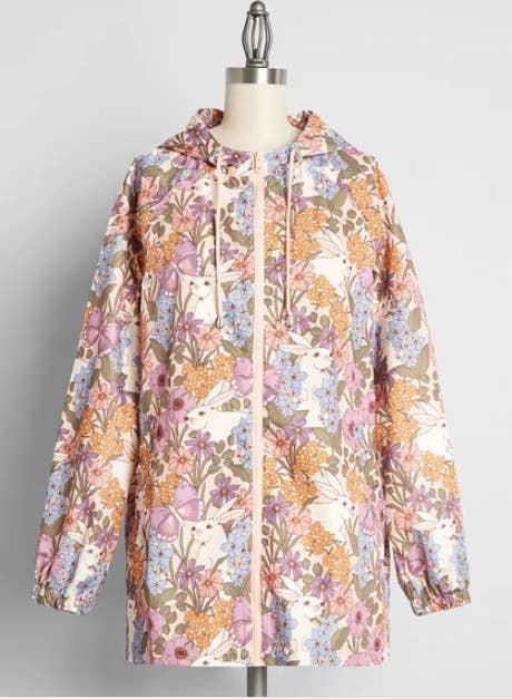 pale pink hooded raincoat printed with orange pink light blue and purple flowers and white rabbits