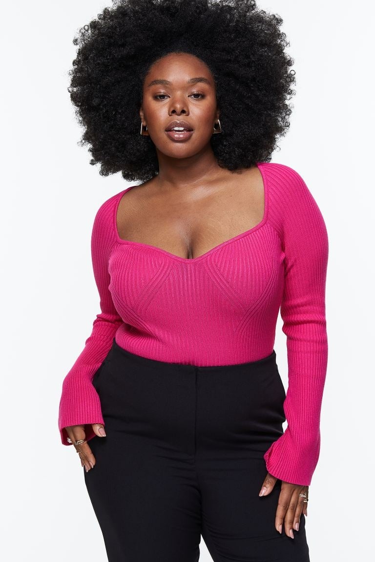 model wearing the knit sweater in bright pink