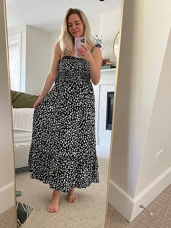 reviewer photo of them wearing a midi polka dot dress in black and white
