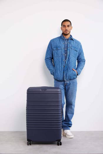the large suitcase in navy blue