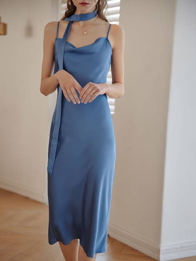 model wearing satin blue dress