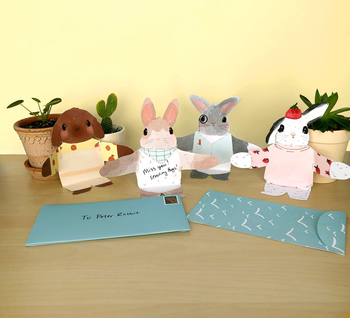 four designs of cards shaped like bunnies wearing clothes, with arms open