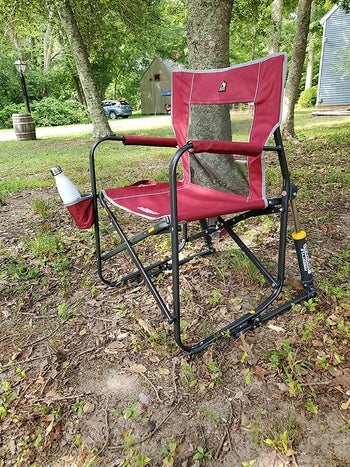 Reviewer image of red outdoor rocking chair with cup older sitting on grass