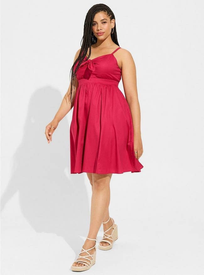 plus size model wearing the pink dress