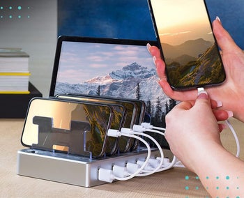 a charging station with phones and a tablet in it