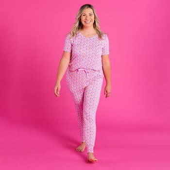 a model in lisa frank rainbow print pajamas