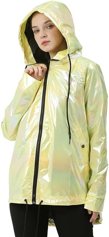 a model wearing a yellow metallic raincoat