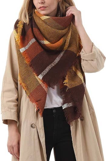 the brown and orange plaid scarf on a model
