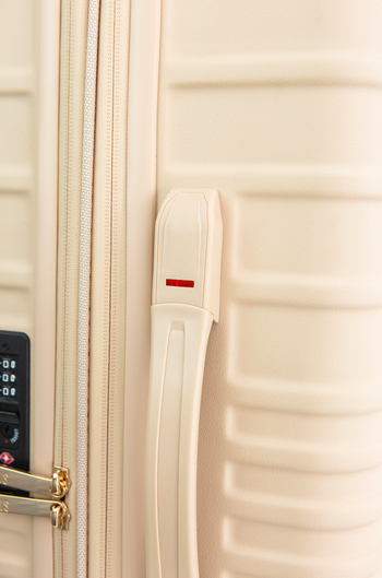 closeup of the suitcase in black, showing the red indicator on the side handle