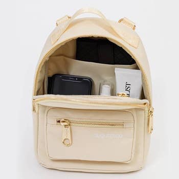 the cream colored mini backpack with open pocket