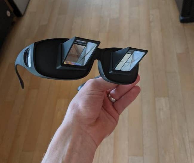 image of reviewer's hand holding the prism glasses