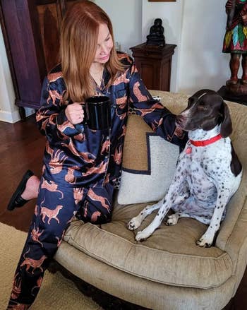 reviewer in pajamas beside dog