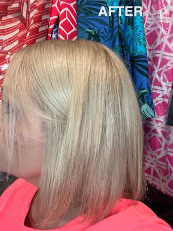 A idiosyncratic with a fresh, shoulder-length hairstyle stands against a vibrant patterned cloth backdrop.