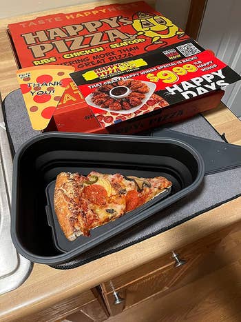leftover pizza slice in triangular container