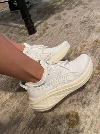 reviewer wearing the white sneakers