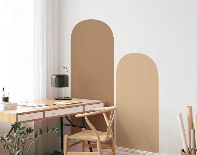 Two different wall decals in different sizes and shades on wall next to a desk