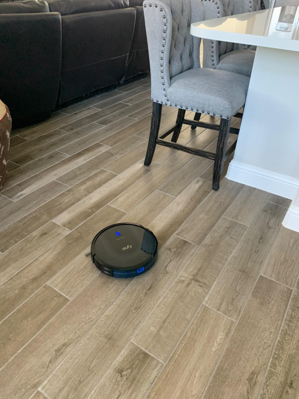 reviewer's robot vacuum running on their hardwood floor