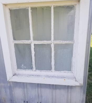 a reviewer photo of a window with a dense hard water film on the glass 