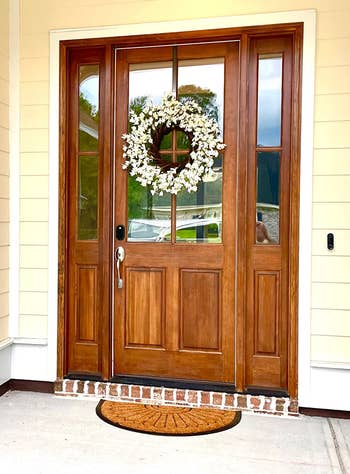 reviewer photo of a white floral wreath on a front door
