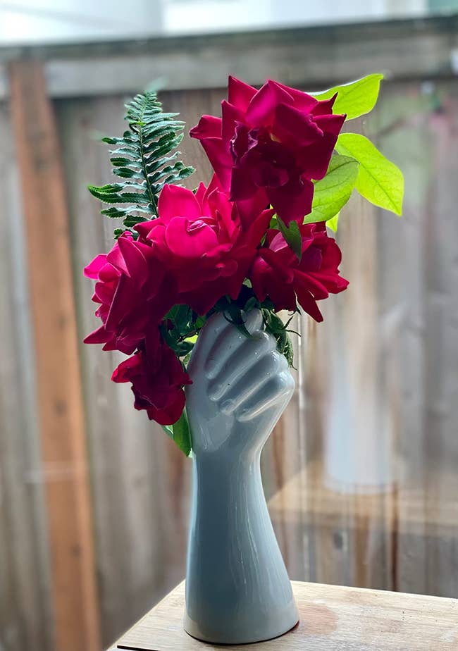 reviewer image of flowers in the hand-shaped vase