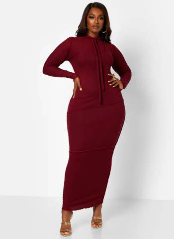 a model wearing the dress in burgundy