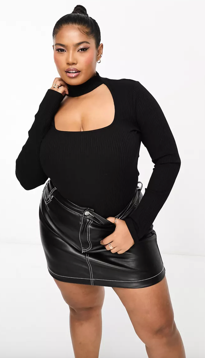 model posing in black long sleeve top with a choker