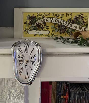 Melting-style clock on a shelf 
