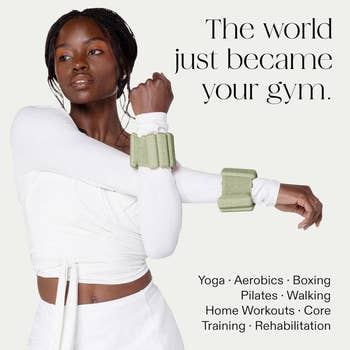 Person wearing wrist weights and a white athletic outfit