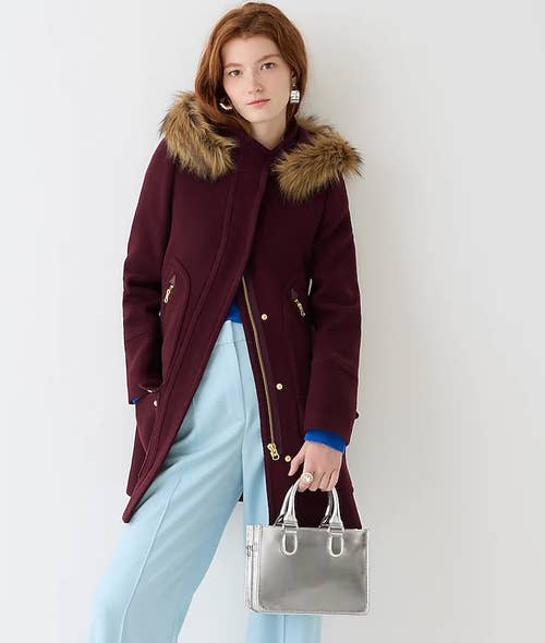 A model wearing the parka in burgundy