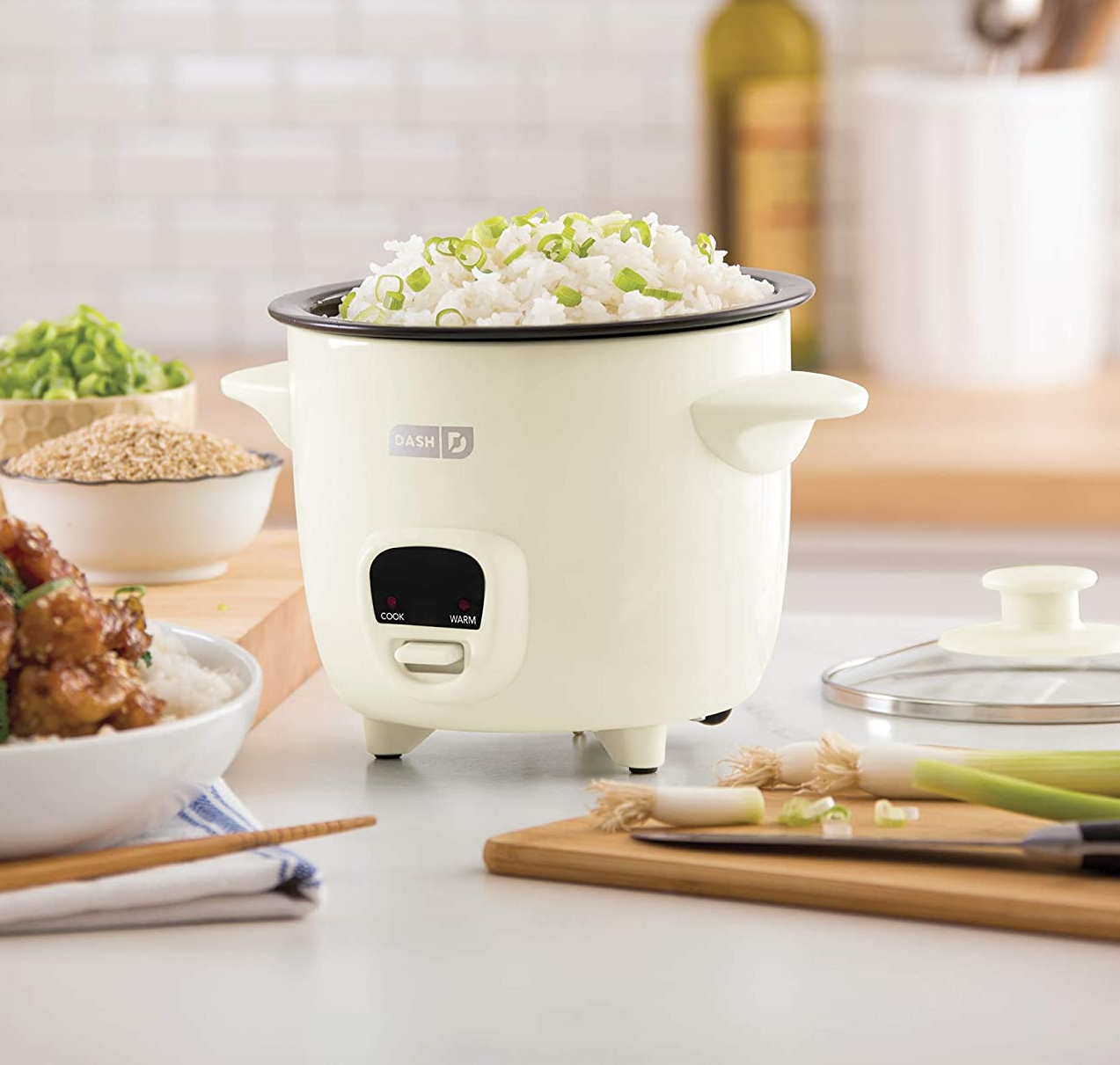 the white rice cooker filled with rice on a kitchen counter