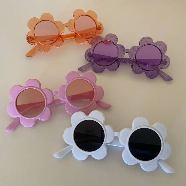 four pairs of flower-shaped sunglasses