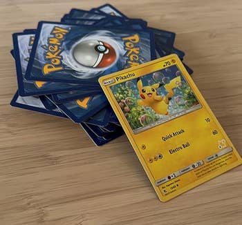 reviewers cards with a Pikachu card face up on a table