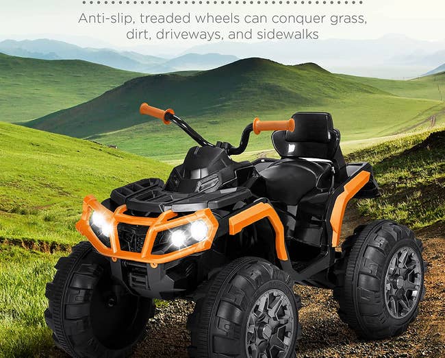 Ride on black ATV toy with bright orange accents